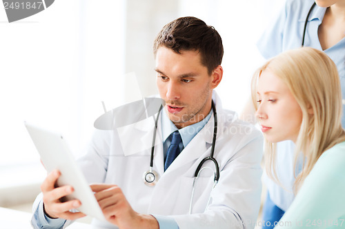 Image of doctor and nurse with patient in hospital