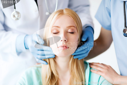 Image of plastic surgeon or doctor with patient