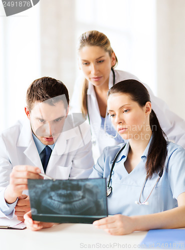 Image of group of doctors looking at x-ray