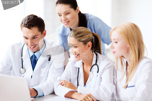 Image of group of doctors looking at tablet pc