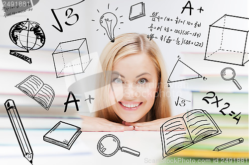 Image of student with stack of books and doodles
