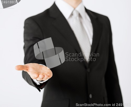 Image of mans hand showing something