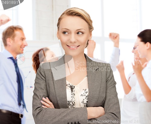 Image of businesswoman celebrating succes in office