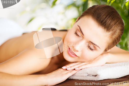 Image of woman in spa with hot stones