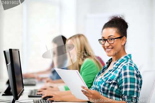 Image of african student with computer studying at school