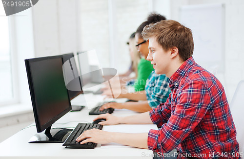 Image of student with computer studying at school