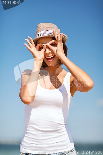 Image of girl making funny faces on the beach
