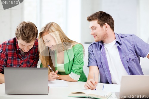 Image of students writing something at school