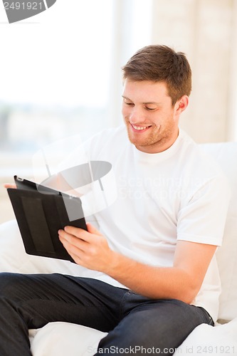 Image of man working with tablet pc at home