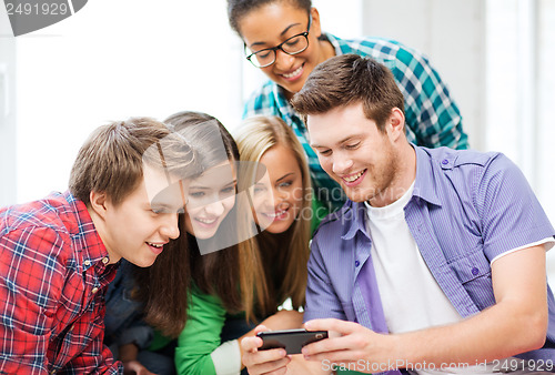 Image of students looking at smartphone at school