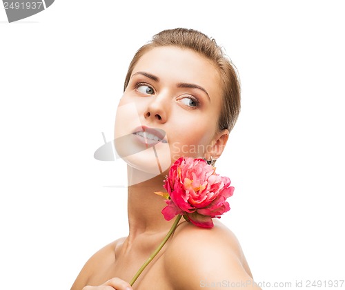 Image of woman with diamond earrings and flower