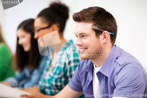 Image of student with computer studying at school