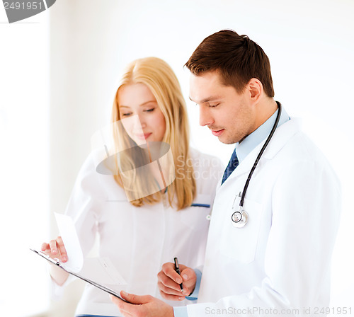 Image of two doctors writing prescription