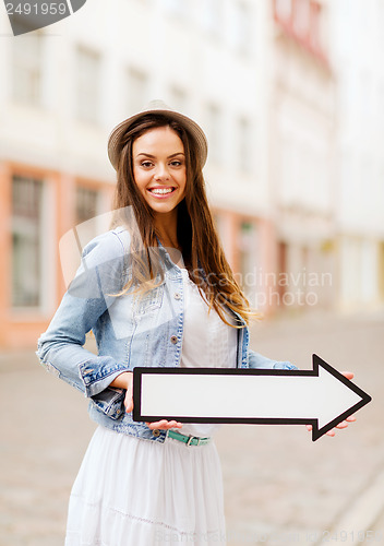 Image of girl showing direction with arrow in the city