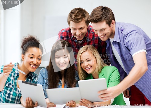 Image of students looking at tablet pc in lecture at school