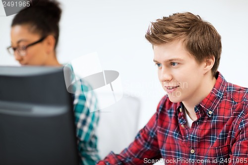 Image of student with computer studying at school