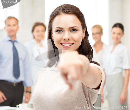 Image of attractive young businesswoman in office