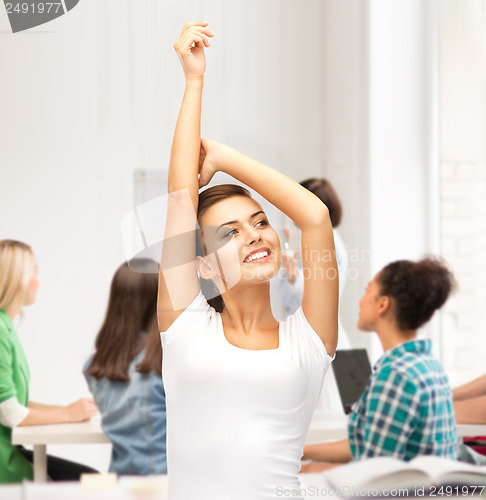 Image of happy student girl with hands up