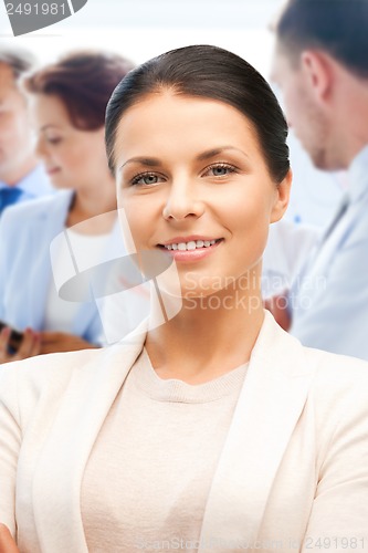 Image of attractive young businesswoman in office