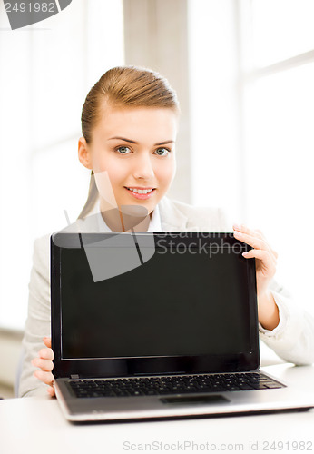 Image of businesswoman with laptop in office