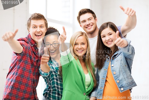 Image of students showing thumbs up at school