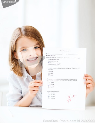 Image of girl with test and grade at school