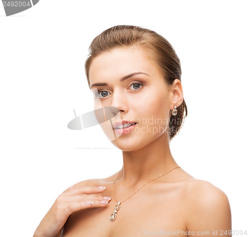 Image of woman wearing shiny diamond earrings