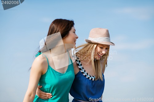 Image of girls walking on the beach