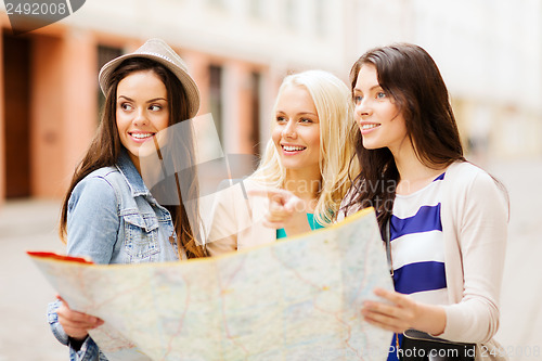 Image of beautiful girls looking for direction in the city