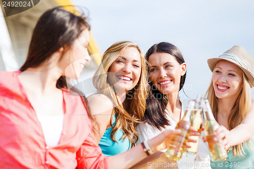 Image of girls with drinks on the beach