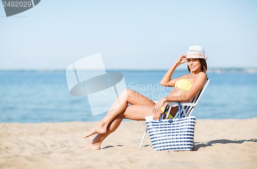 Image of girl sunbathing on the beach chair