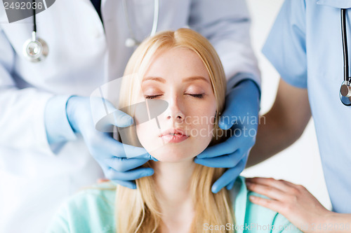 Image of plastic surgeon or doctor with patient