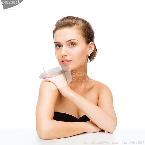 Image of woman with earrings and wedding ring