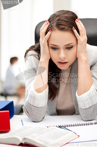 Image of stressed businesswoman in office