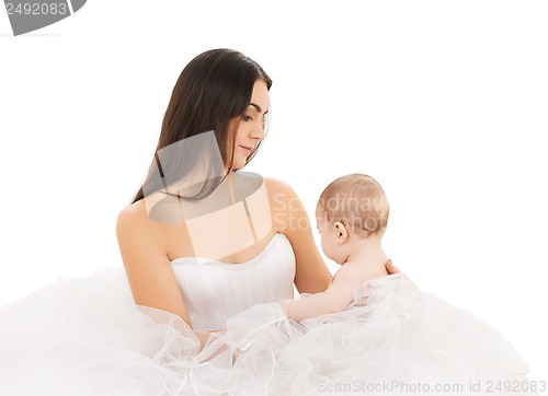 Image of bride in white dress with little baby