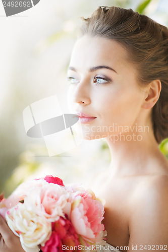 Image of young woman with bouquet of flowers