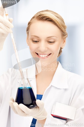 Image of female chemist holding bulb with chemicals