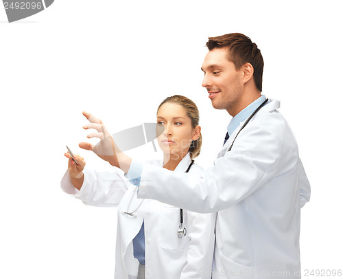 Image of young doctors working with something imaginary