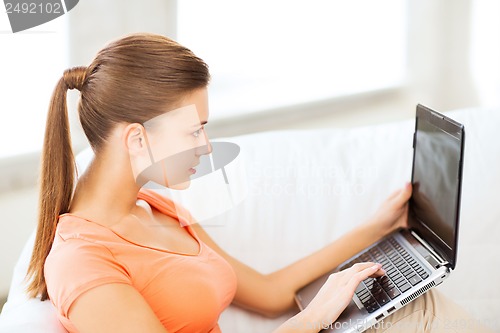 Image of woman using laptop at home