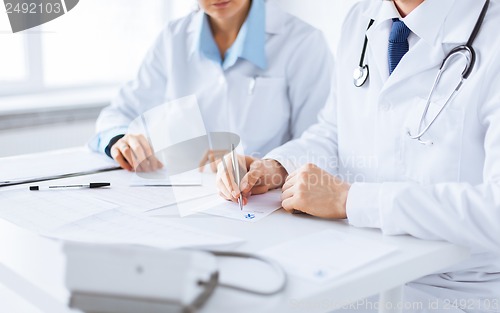 Image of doctor and nurse writing prescription paper