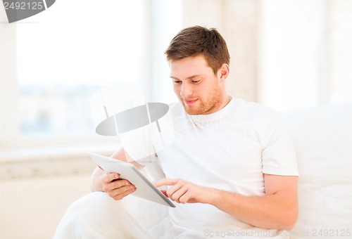 Image of man working with tablet pc at home