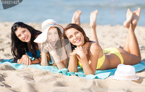 Image of girls sunbathing on the beach