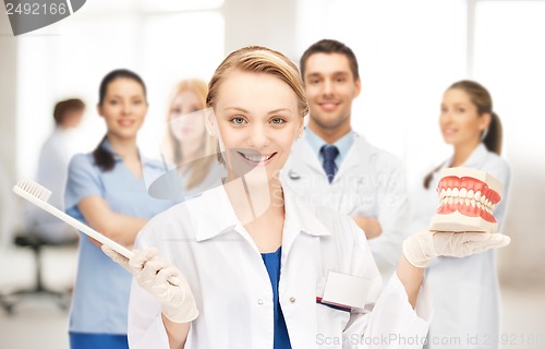 Image of doctor with toothbrush and jaws