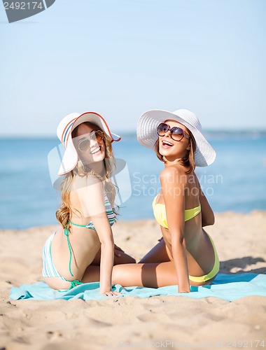 Image of girls sunbathing on the beach