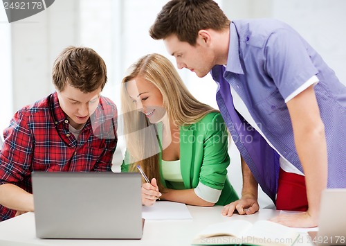 Image of students writing test or exam in lecture at school