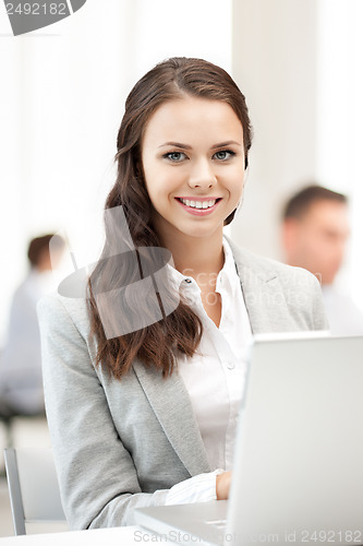 Image of businesswoman with laptop computer at work