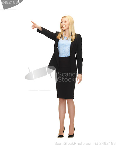 Image of attractive businesswoman pointing at something