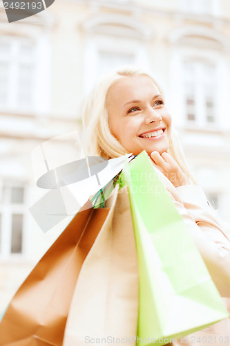 Image of woman with shopping bags in ctiy