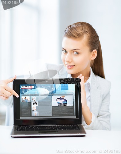 Image of woman showing laptop pc with news