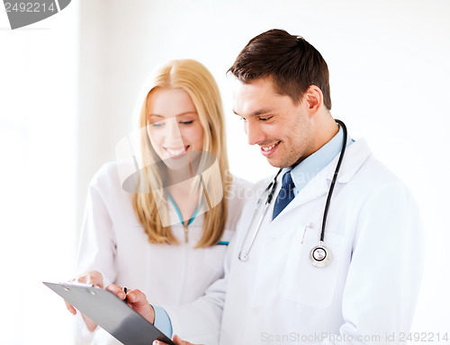 Image of two doctors writing prescription